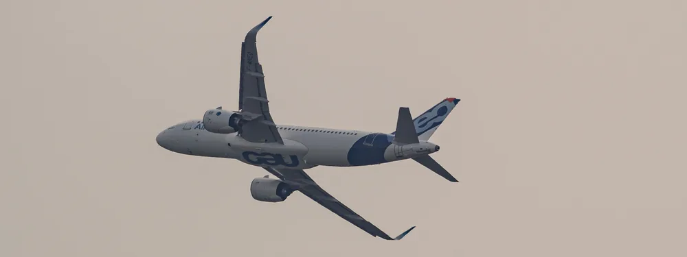 Airbus A320neo prototype F-WNEO in Airbus house colors flying against a pale sky